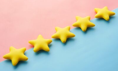 five yellow stars on blue and pink background
